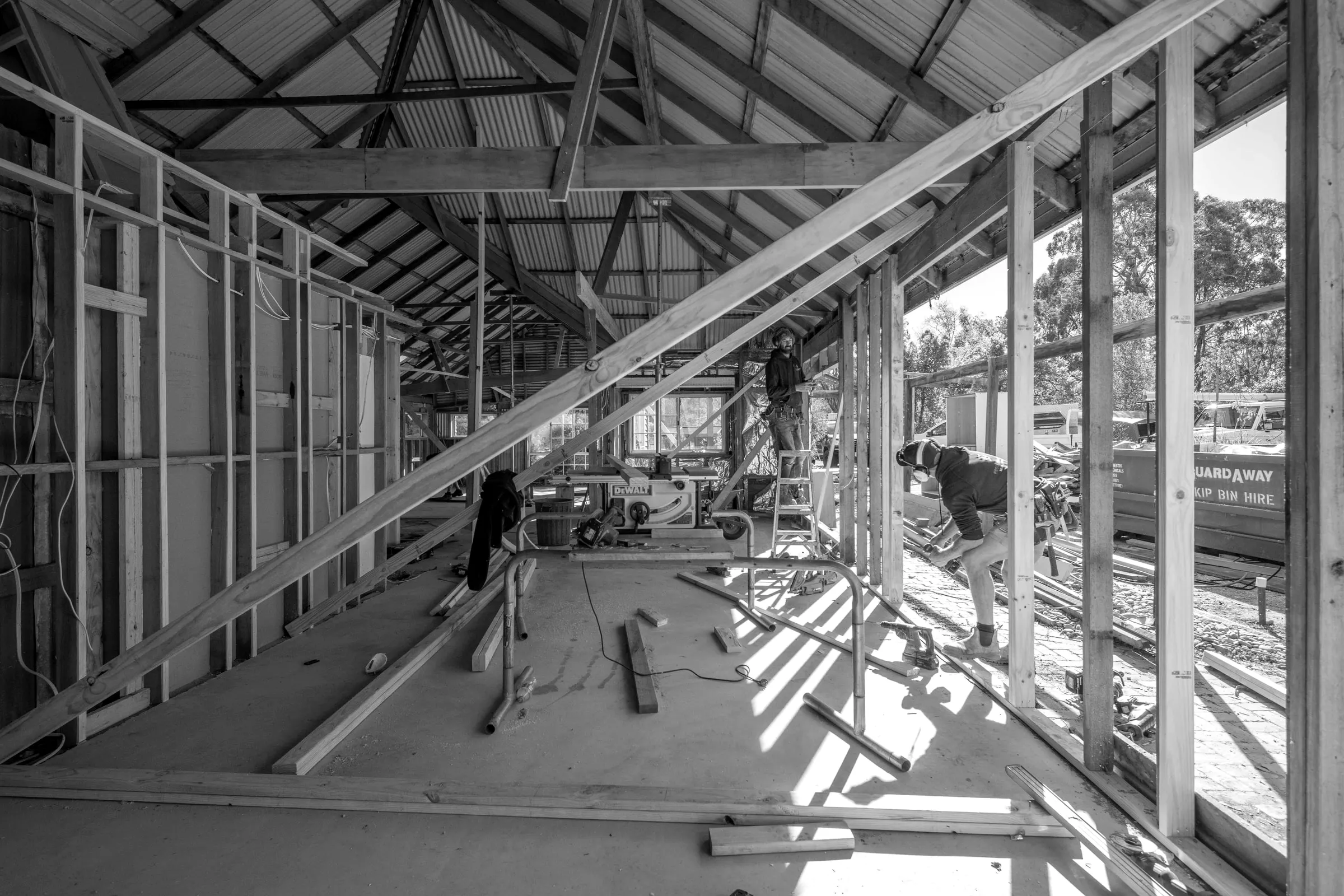 New roof framing going on over the original timber walls of a cottage, Relbia